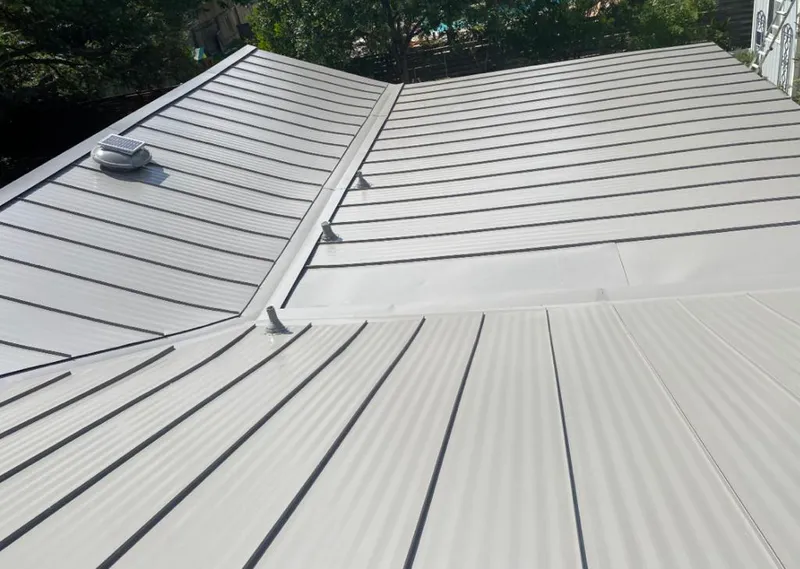 Solar attic fan installed on a metal roof for Roof Ventilation in Oakville